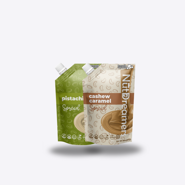 Two Nut Dreamers spreads one pistachio and one cashew caramel, on a light gray background.